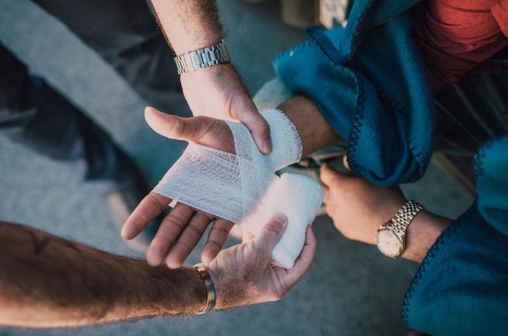 hand being bandaged